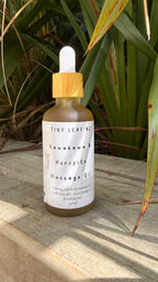 Tiny Leaf NZ Kawakawa and Horopito massage oil in glass bottle with wooden lid, natural botanical body oil for relaxation