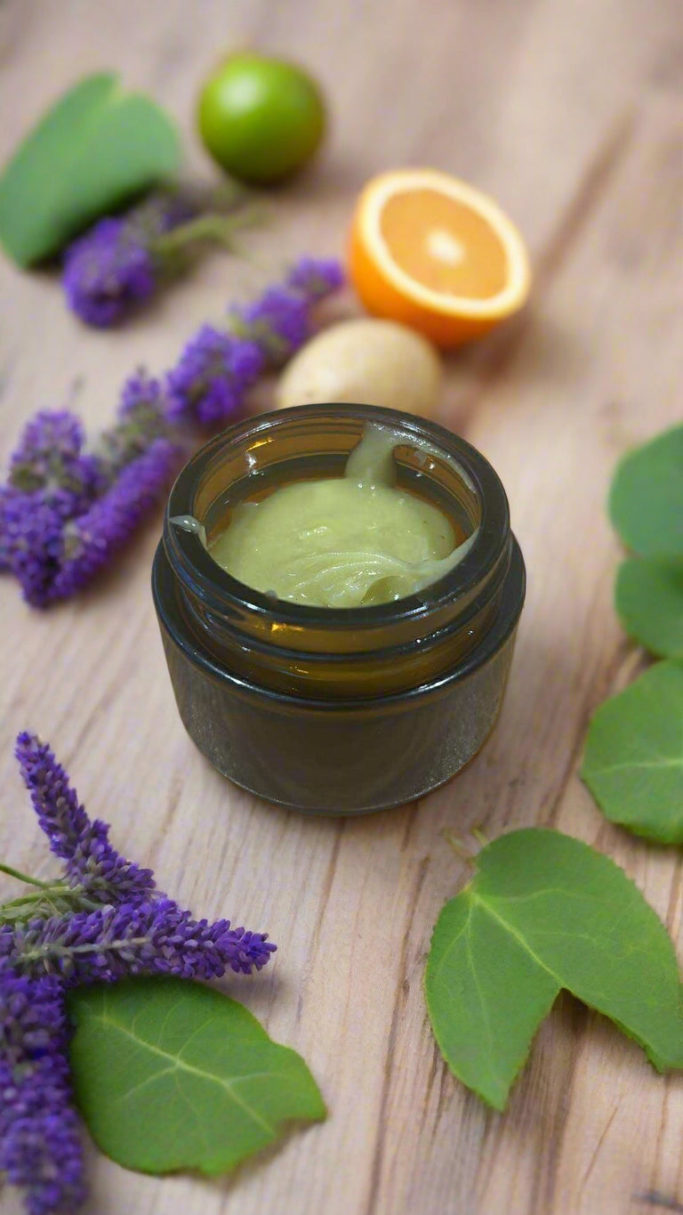 Small brown glass jar with green substance on a wooden surface