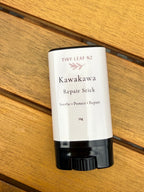 Kawakawa repair stick by Tiny Leaf NZ on a wooden surface