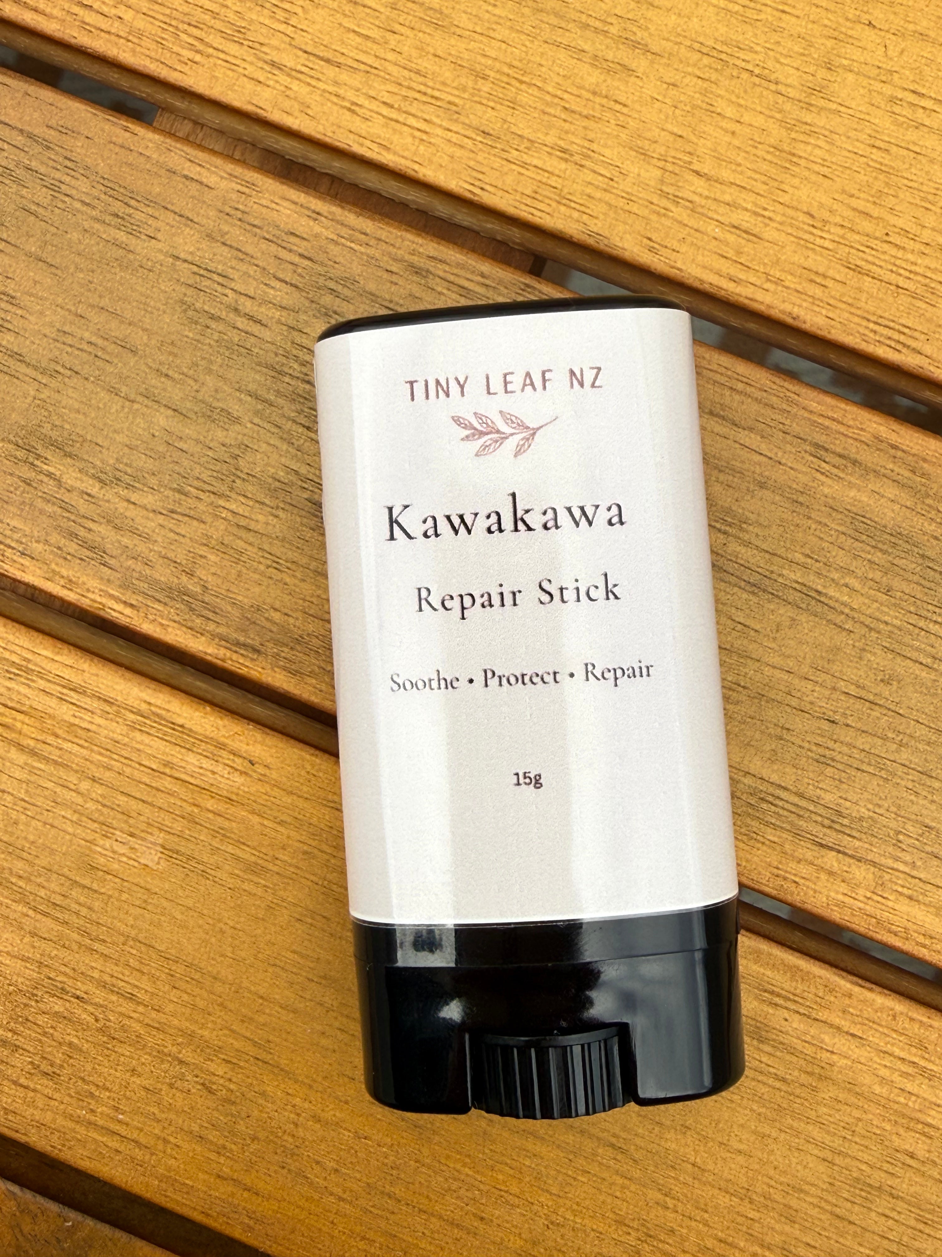 Kawakawa repair stick by Tiny Leaf NZ on a wooden surface