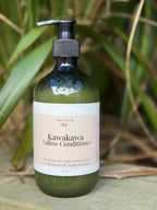 Green bottle of Kawakawa Tallow Conditioner with a pump on a natural background