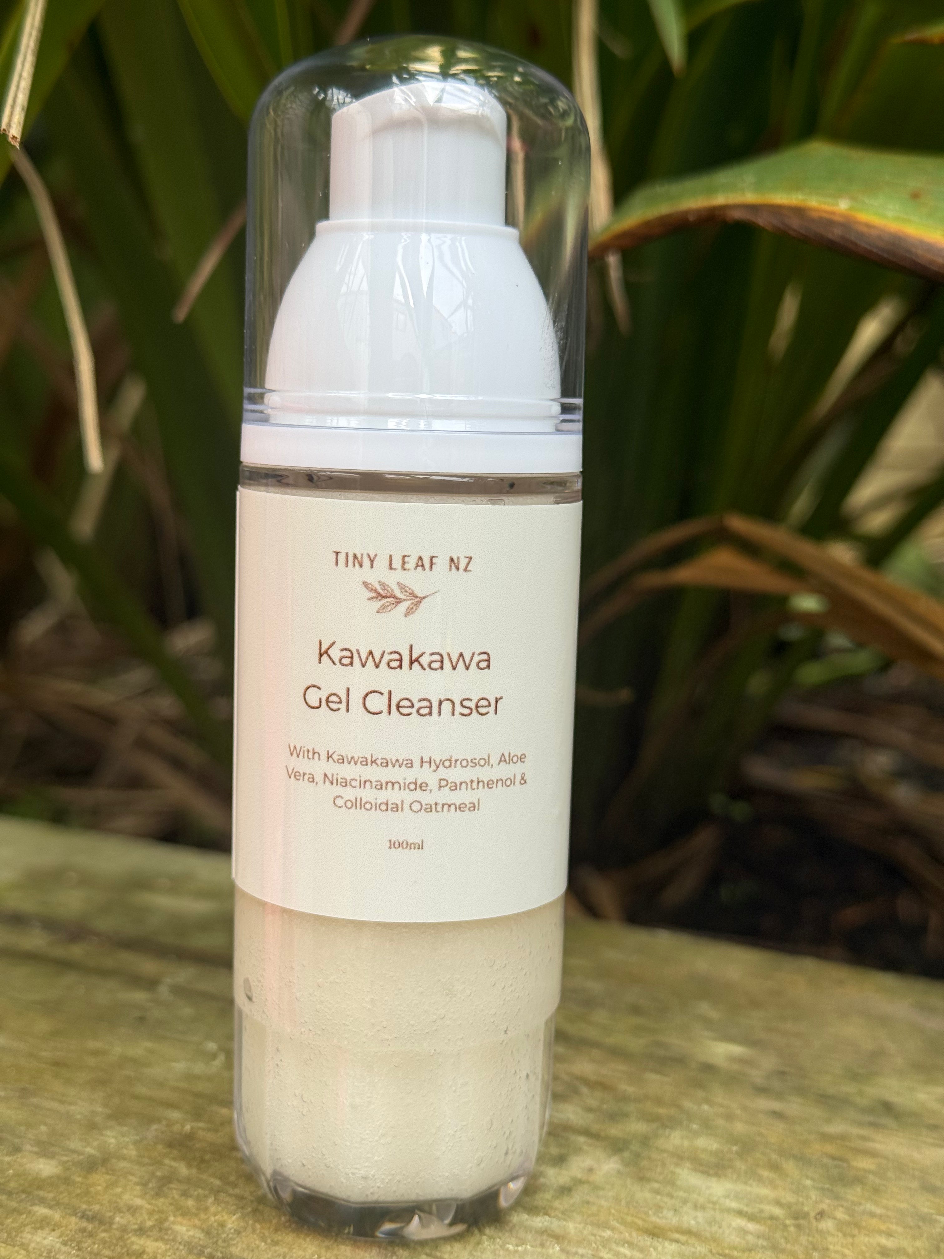A 300ml bottle of Tiny Leaf NZ Kawakawa Gel Cleanser with a white pump and clear cap, set outdoors on a stone surface with green foliage in the background.