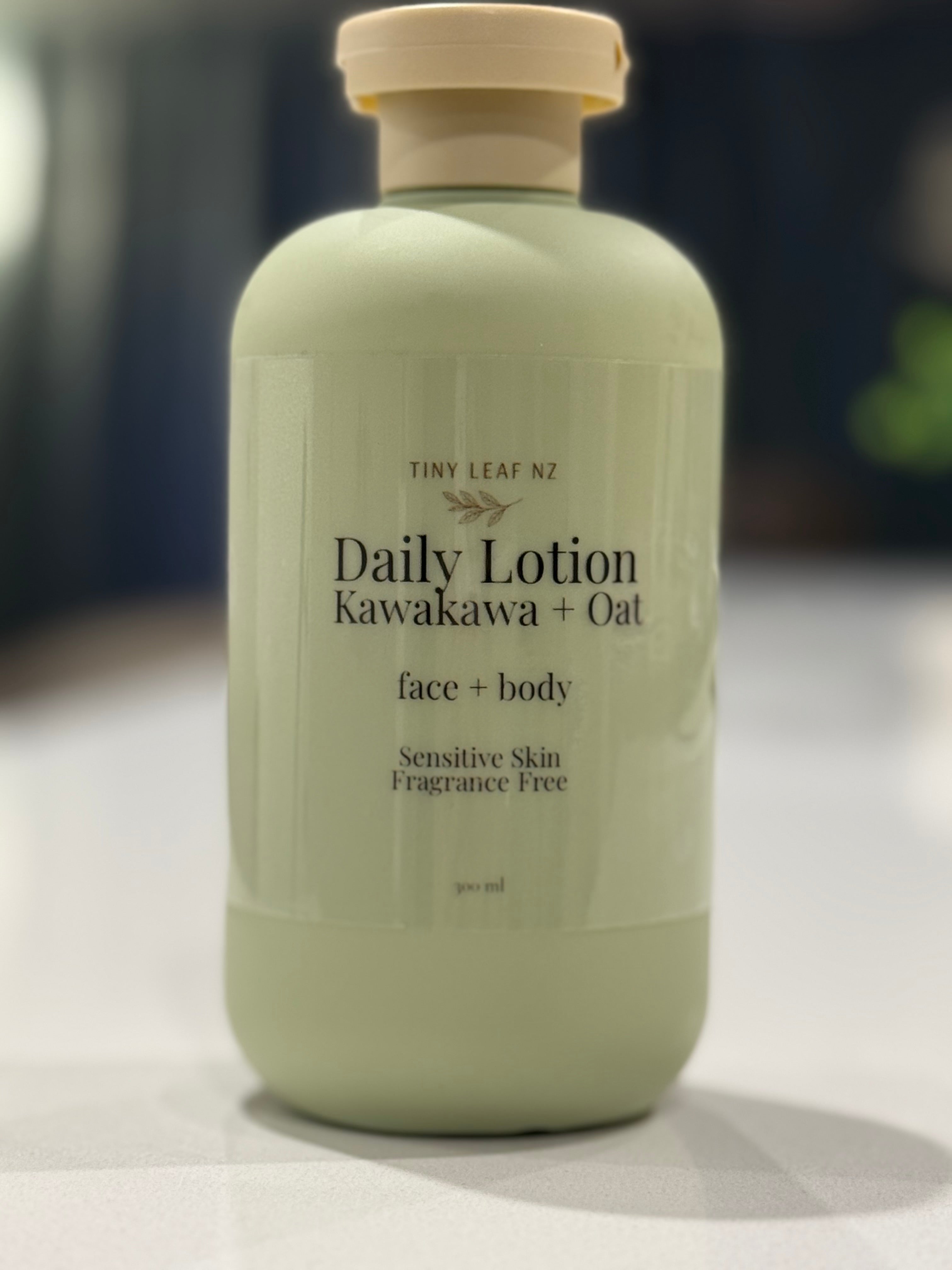 Minimalist product photo of Tiny Leaf NZ Daily Lotion Kawakawa + Oat in a soft sage green bottle on a white marble stone