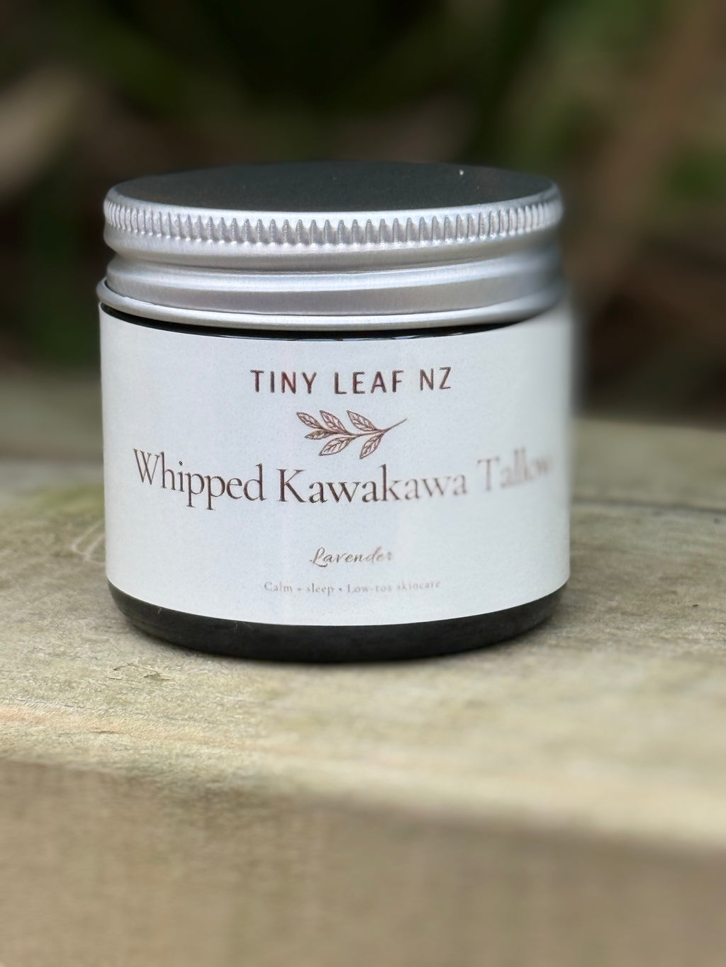Jar of Tiny Leaf NZ Whipped Kawakawa Tallow on a wooden surface