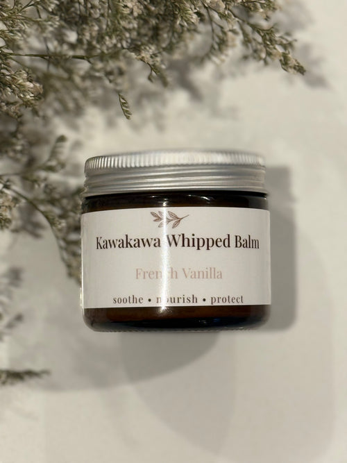 Jar of Kawakawa Whipped Balm with a white label on a light background