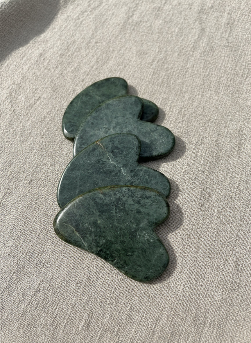 Set of green stones on a metallic surface