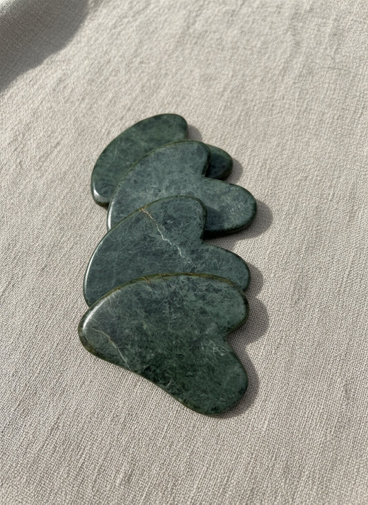Set of green stones on a metallic surface