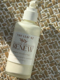 A bottle of Tiny Leaf NZ Tallow Manuka Renew Night Moisturiser, filled with a creamy off-white liquid, resting on a woven straw mat.