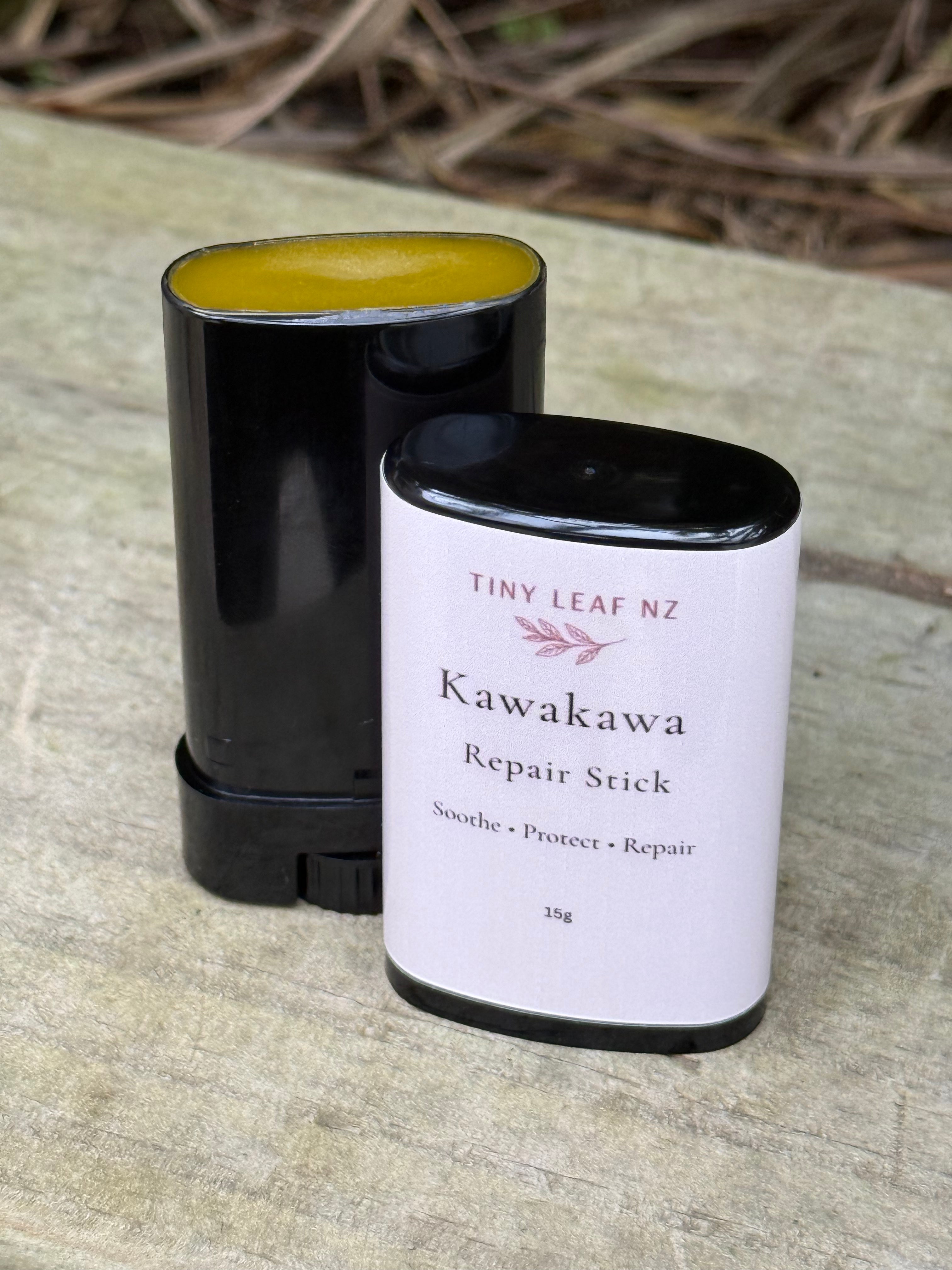 Kawakawa repair stick with black cap on a wooden surface