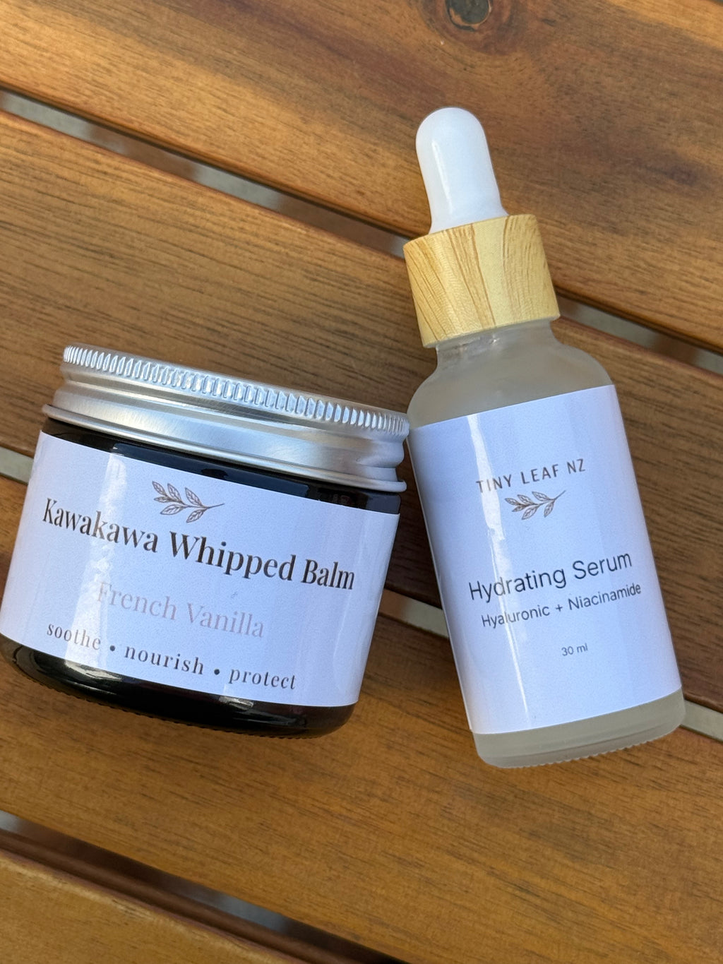 Kawakawa Whipped Balm and Hydrating Serum on a wooden surface