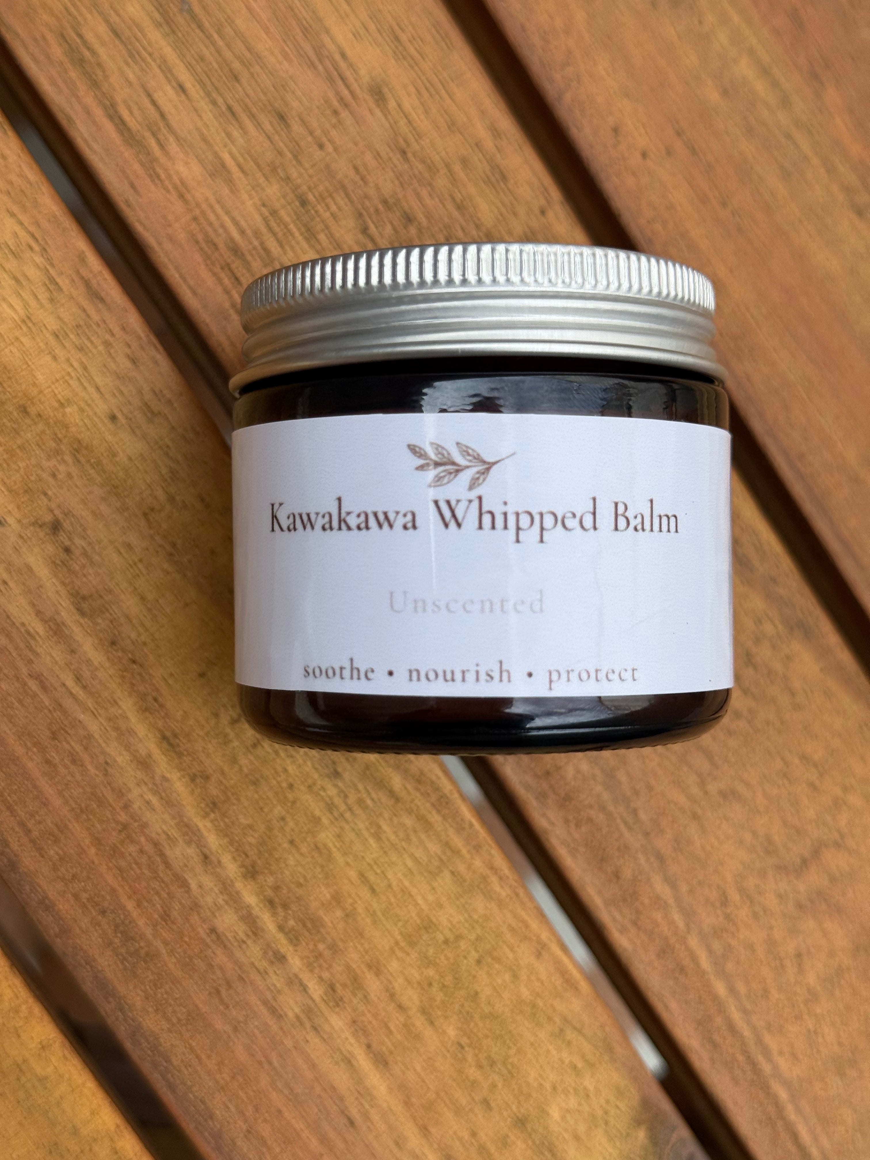 Jar of Kawakawa Whipped Balm on a wooden surface