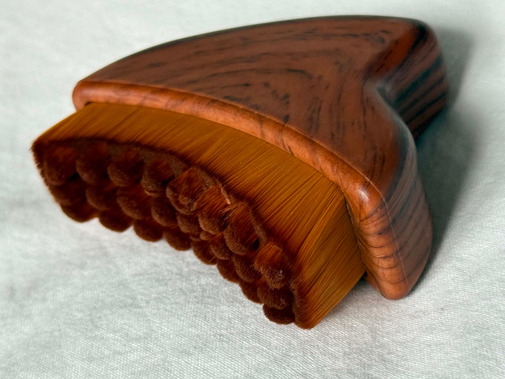 Wooden brush with bristles on a white background