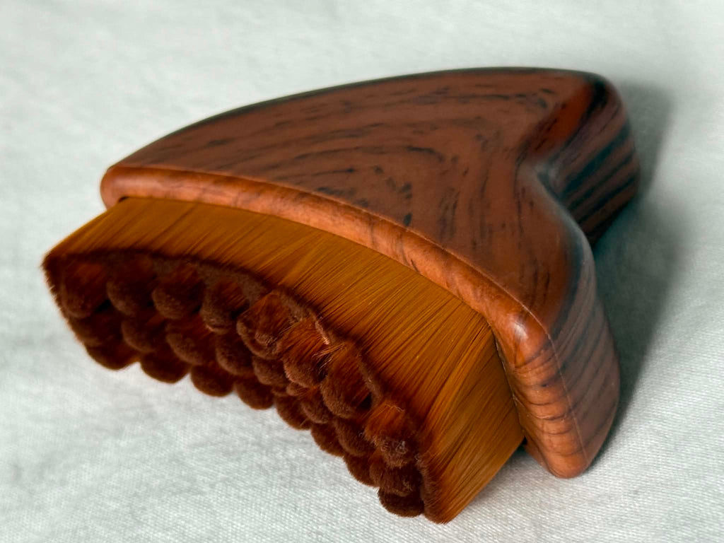Wooden brush with bristles on a white background