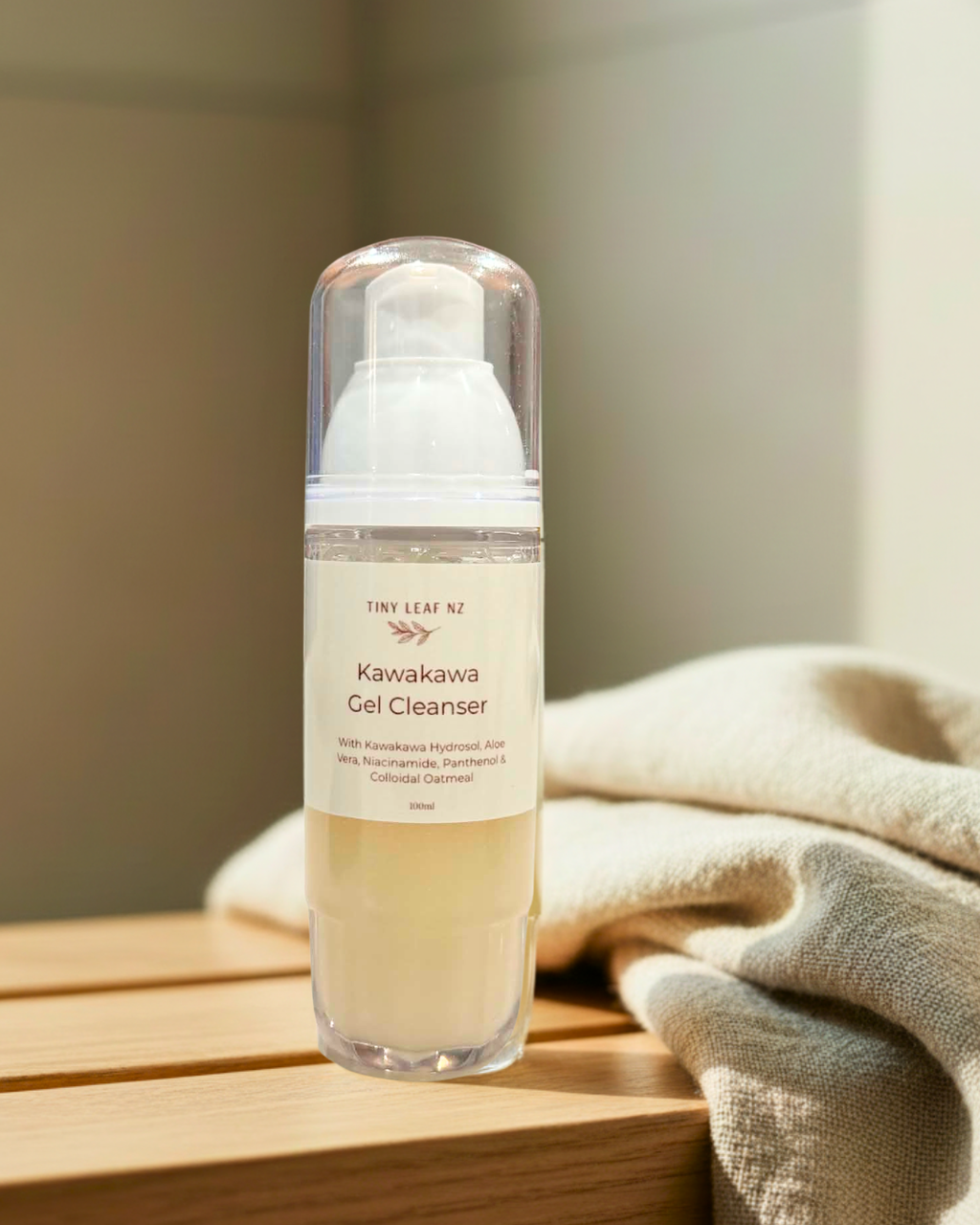 Kawakawa Gel Cleanser bottle on a wooden surface with a neutral background