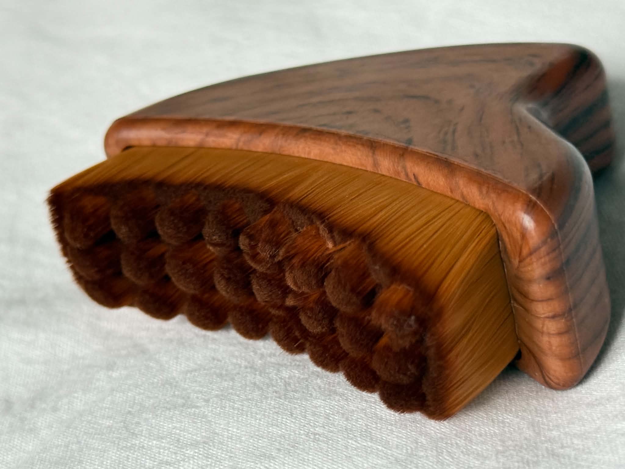 Wooden brush with bristles on a white background