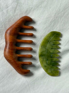 Wooden and green stone comb on a white background