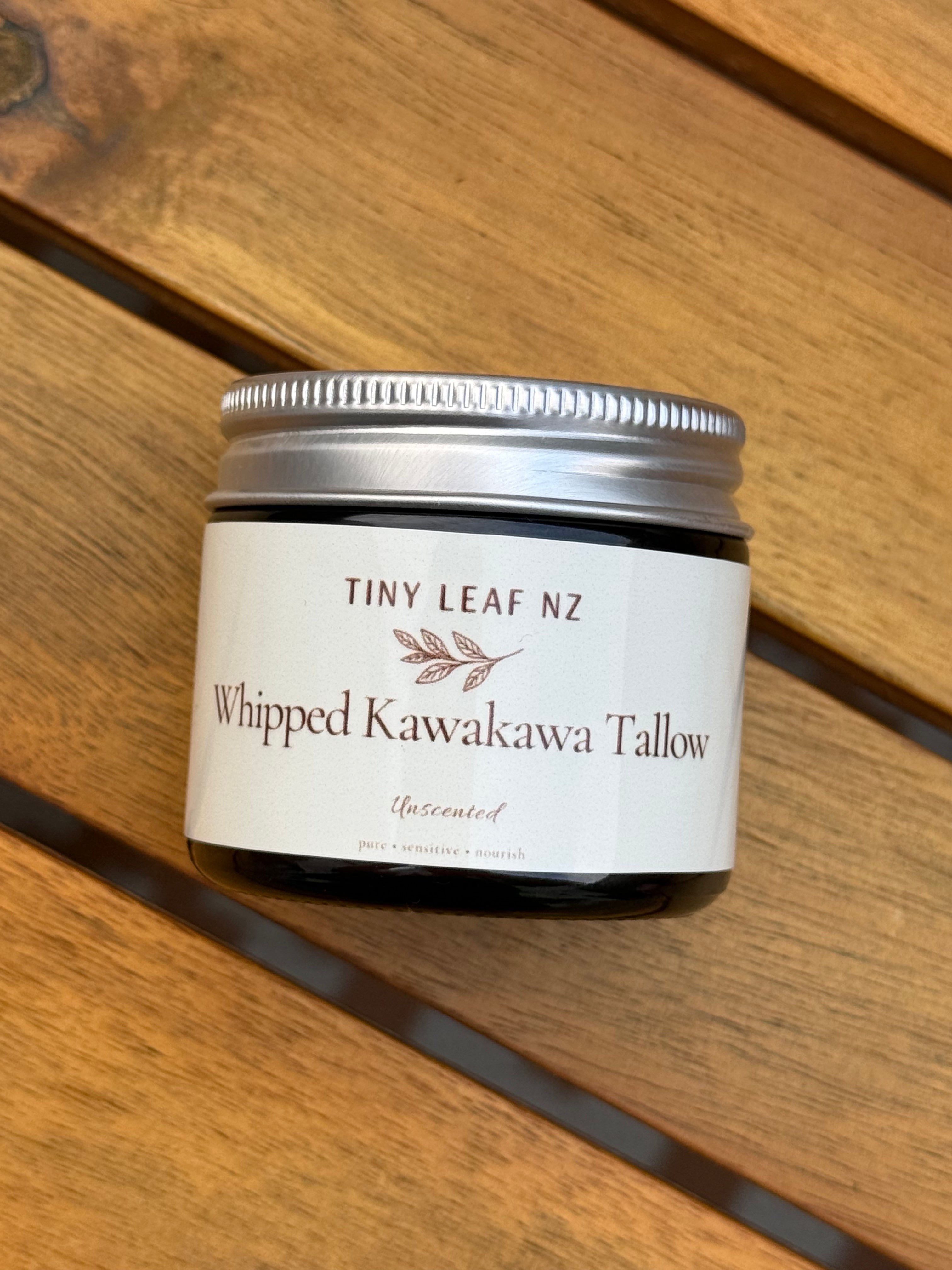 Jar of 'Whipped Kawakawa Tallow' by Tiny Leaf NZ on a wooden surface